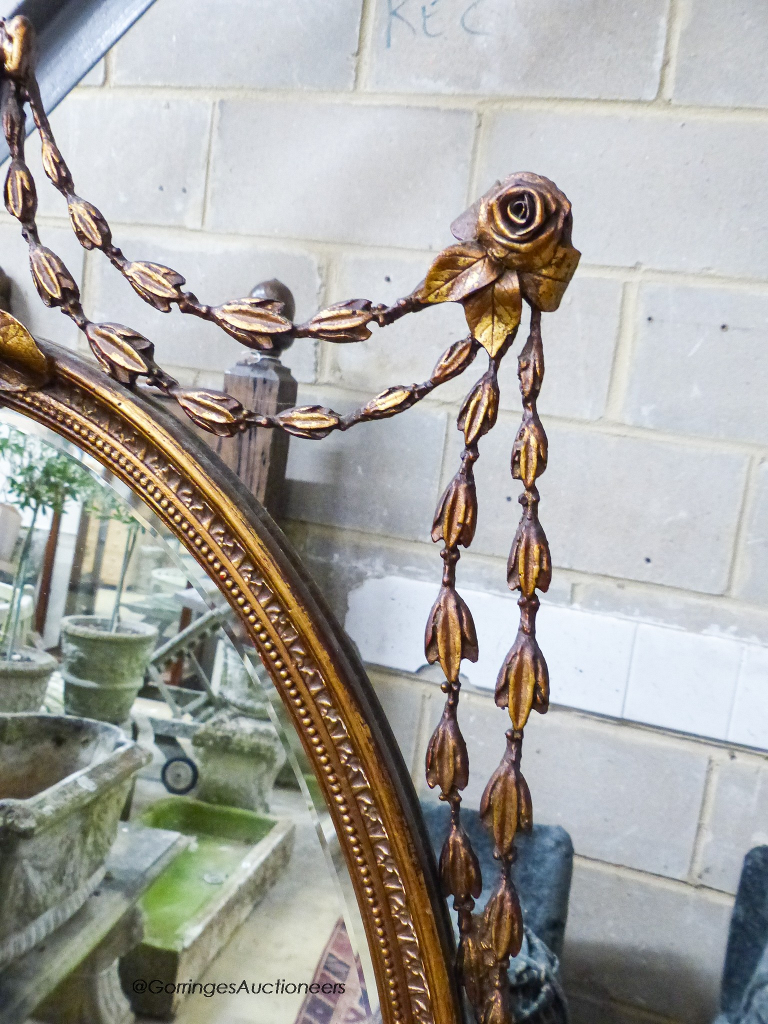 An oval Victorian style gilt wall mirror, width 70cm, height 120cm